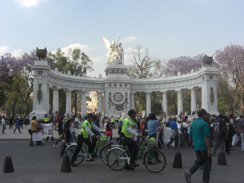 Protesters stream passed the Hemiciclo a Juarez monument, Mexico City